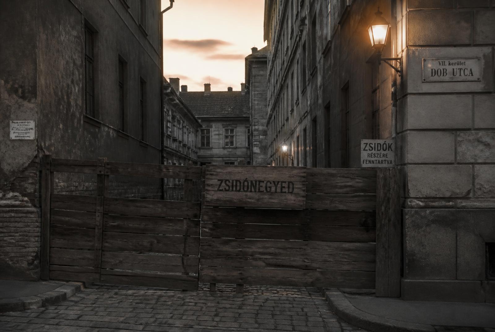 1940s wartime ghetto street with wooden barrier in the Budapest Jewish Quarter — WWII filming location