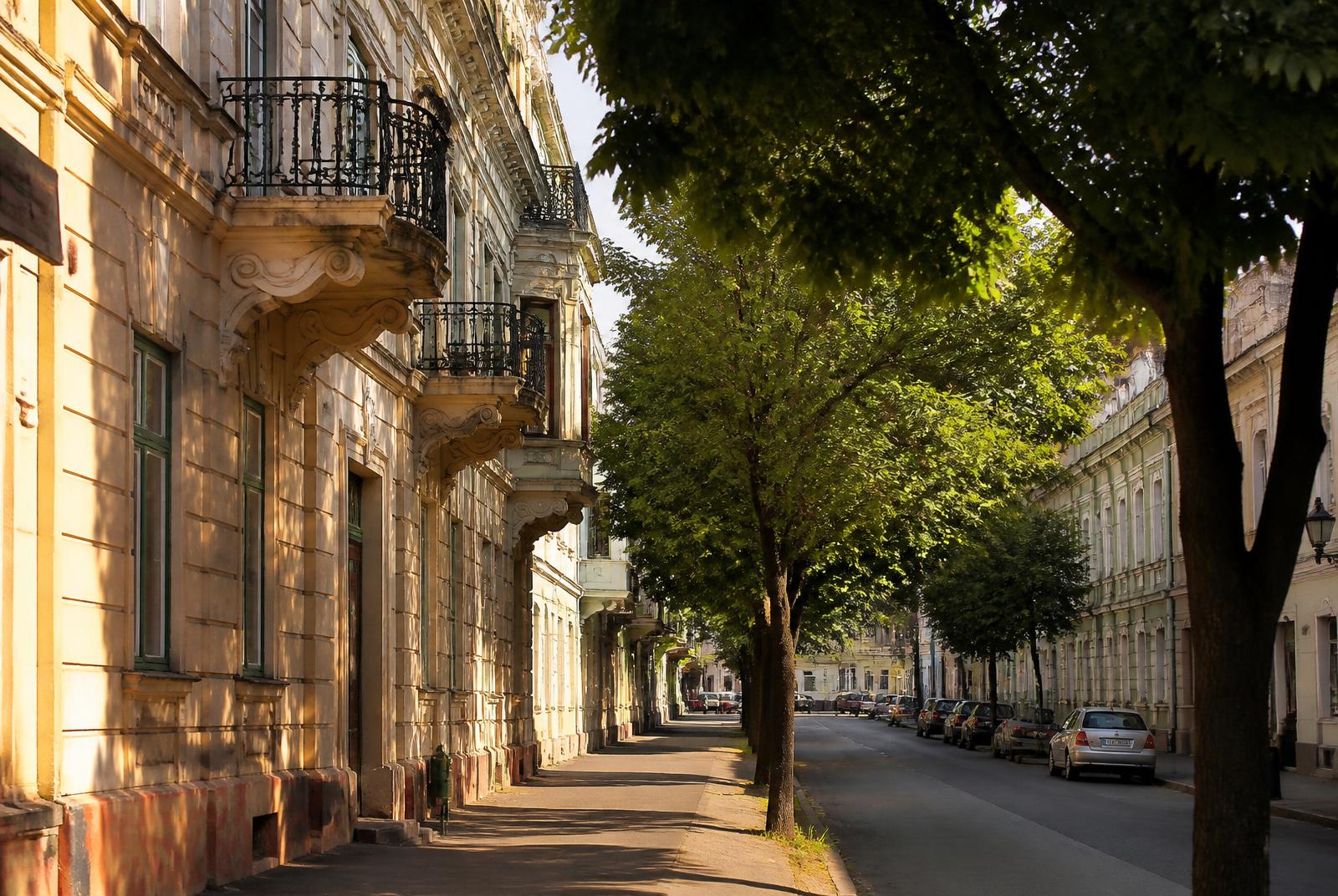 Quiet period residential street with iron balconies in Debrecen, Hungary